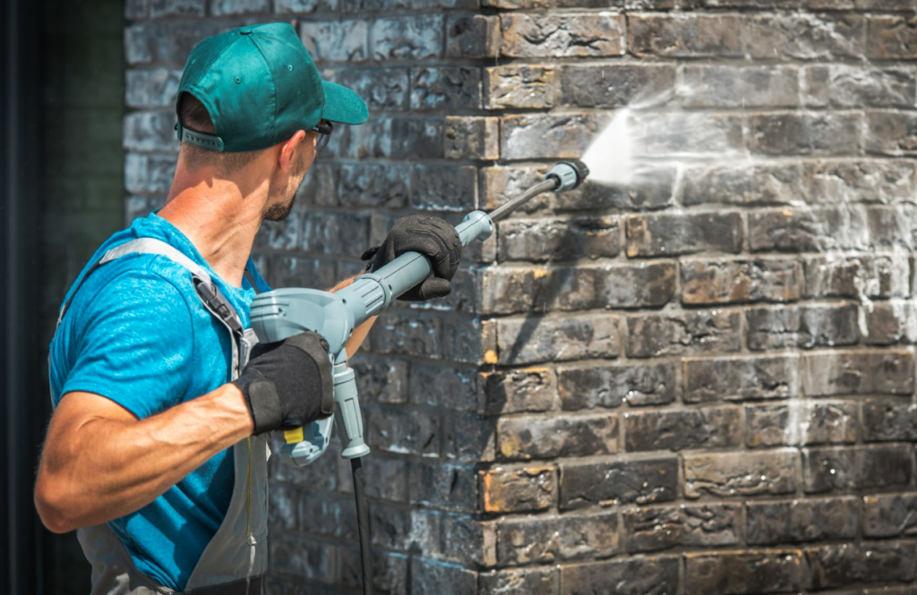 Pressure washing exterior of building